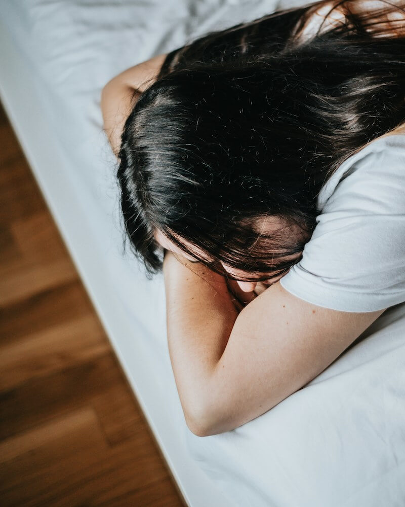 anxious person laying in bed